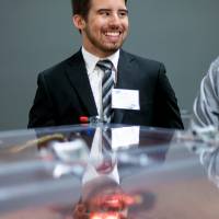 Students stand near their project